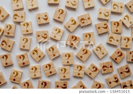 A large collection of wooden tiles with too many question marks. The shallow depth of field emphasizes sea of inquiries and ideas A large collection of wooden tiles with too many question marks. The shallow depth of field emphasizes sea of inquiries and ideas 138451015