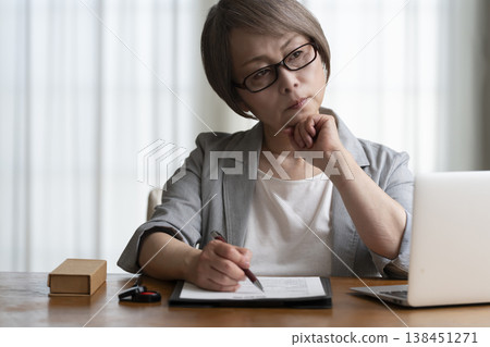 Senior woman hesitant to sign and seal contract - negative Senior woman hesitant to sign and seal contract - negative 138451271