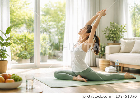 Woman doing yoga in the living room 138451350