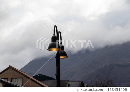 The streetlights glow faintly The streetlights glow faintly 138451406