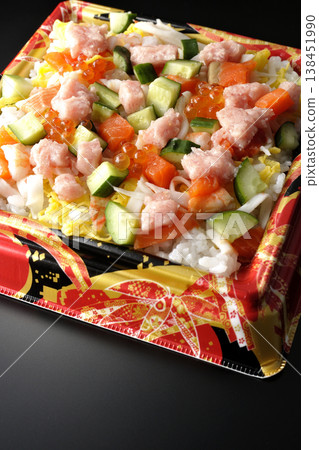 A photo of a generously topped chirashi sushi against a black background. A photo of a generously topped chirashi sushi against a black background. 138451990