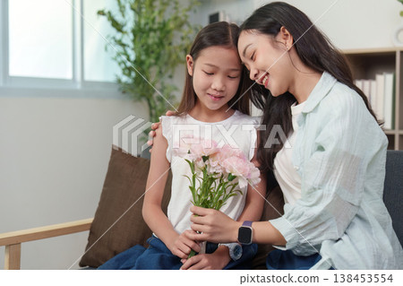 Mother and daughter bonding over flowers and gifts 138453554