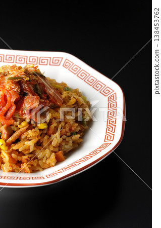 Spicy kimchi fried rice photographed alone against a black background. Spicy kimchi fried rice photographed alone against a black background. 138453762