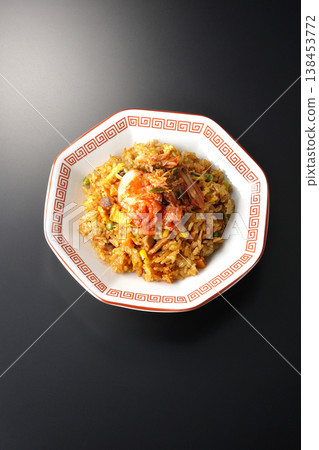 Spicy kimchi fried rice photographed alone against a black background. Spicy kimchi fried rice photographed alone against a black background. 138453772