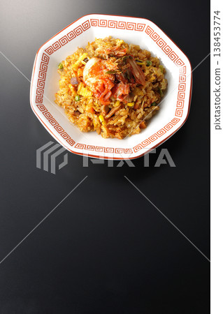 Spicy kimchi fried rice photographed alone against a black background. Spicy kimchi fried rice photographed alone against a black background. 138453774
