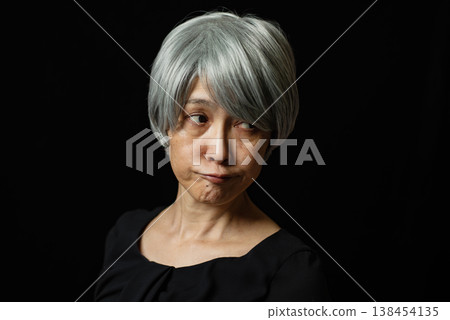 A senior woman with white hair pouts, looking exasperated. A senior woman with white hair pouts, looking exasperated. 138454135
