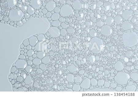 The texture of the foam of shower gel or soap suds or shaving foam. Macrophotography The texture of the foam of shower gel or soap suds or shaving foam. Macrophotography 138454188