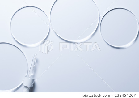 Glass circles on a blue background. A template for placing samples of cosmetics or medical products or food. 138454207