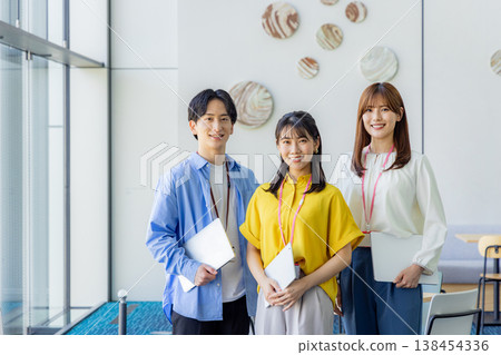 A smiling man and woman holding laptops. A smiling man and woman holding laptops. 138454336