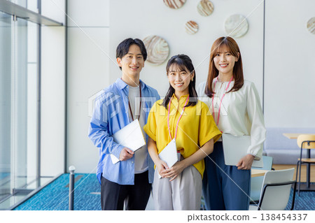 A smiling man and woman holding laptops. A smiling man and woman holding laptops. 138454337