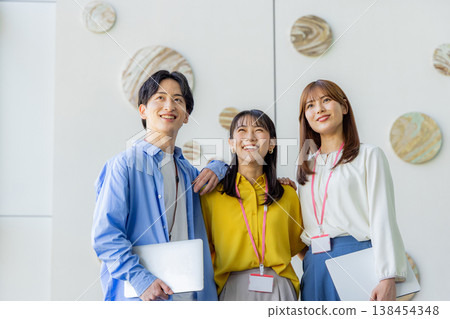 A smiling man and woman holding laptops. A smiling man and woman holding laptops. 138454348