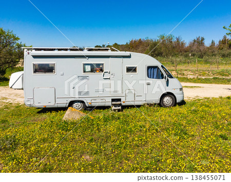 Camping car parked in a field with blue sky during daytime in a rural area 138455071