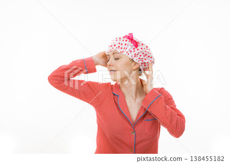 Funny woman wearing pajamas and bathing cap 138455182