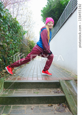 Woman wearing sportswear exercising outside during autumn Woman wearing sportswear exercising outside during autumn 138455192