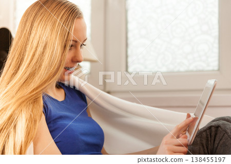 Young woman relaxing with tablet Young woman relaxing with tablet 138455197