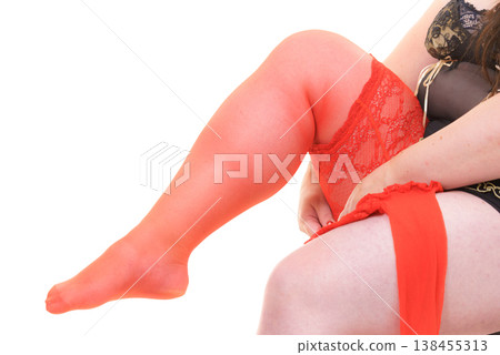 Woman plus size puts on red nylon stockings 138455313