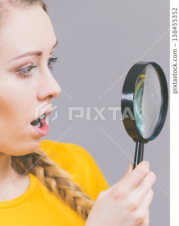 Shocked woman magnifying bun bread roll Shocked woman magnifying bun bread roll 138455352