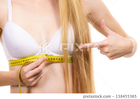 Girl measuring her chest under breast 138455365