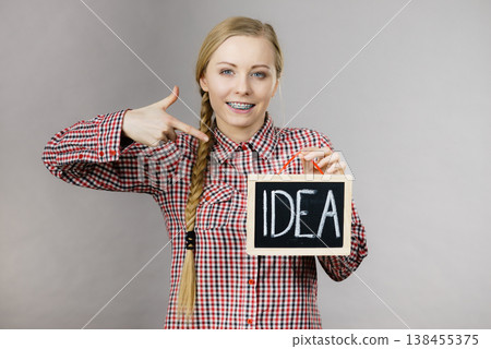 Happy positive woman holding idea sign 138455375