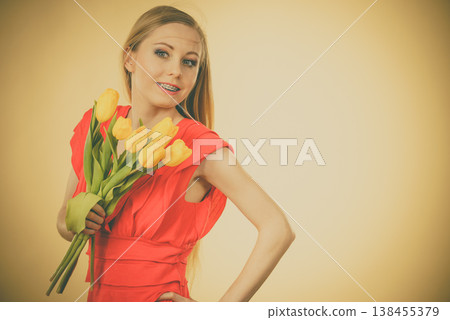 Pretty woman with yellow tulips bunch Pretty woman with yellow tulips bunch 138455379