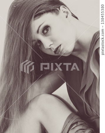 Sad elegant woman sitting on sofa 138455380