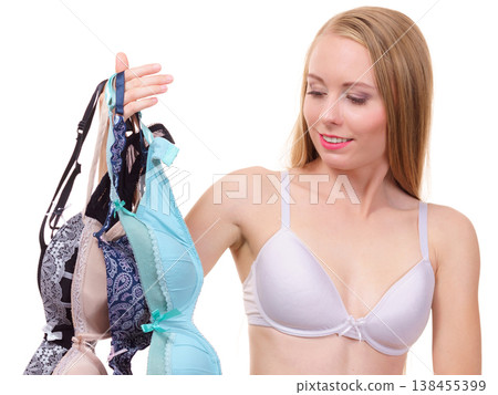 Woman holds bras, choosing Woman holds bras, choosing 138455399