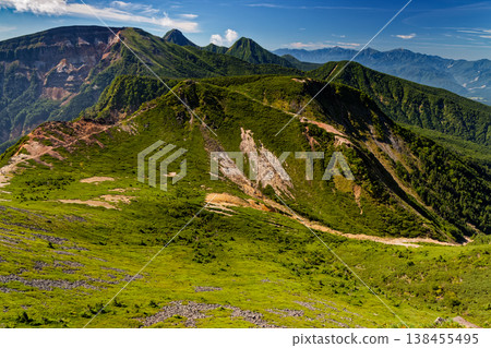 A view of Mt. Iou, Mt. Akadake, Mt. Amidadake, and the Southern Alps from Mt. Higashi-Tengudake in the Yatsugatake mountain range. 138455495
