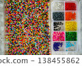 Close up of colorful seed beads in square sections pink shades, flat lay 138455862