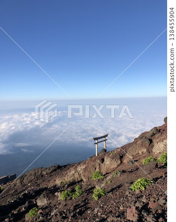 Torii gate and sea of clouds at the summit of Mt. Fuji (Copy space: Blue sky) Torii gate and sea of clouds at the summit of Mt. Fuji (Copy space: Blue sky) 138455904