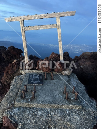 The torii gate at the summit of Mt. Fuji, the red lava, and the light of dawn. The torii gate at the summit of Mt. Fuji, the red lava, and the light of dawn. 138455906