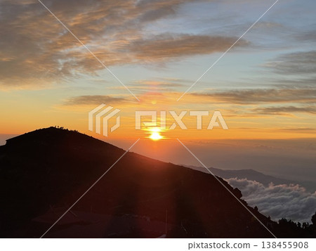 Sunrise from the summit of Mt. Fuji and the silhouette of the mountain. 138455908