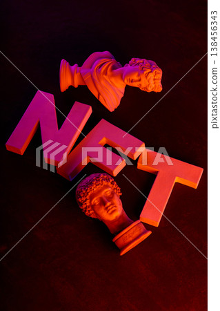 NFT text with classical sculpture busts illuminated in vibrant neon pink and orange gradient lighting NFT text with classical sculpture busts illuminated in vibrant neon pink and orange gradient lighting 138456343