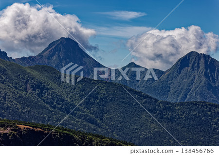 A view of Akadake and Amidadake, shrouded in clouds, from Nishitengudake in the Yatsugatake mountain range. 138456766