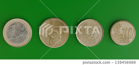 euro coins isolated on green background euro coins isolated on green background 138456989