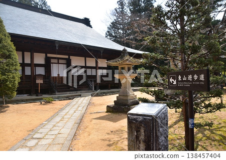 In the old town of Takayama City, Gifu Prefecture, Japan, a retro temple is located on the Higashiyama walking trail, featuring deep, traditional Japanese wooden architecture and an information sign. In the old town of Takayama City, Gifu Prefecture, Japan, a retro temple is located on the Higashiyama walking trail, featuring deep, traditional Japanese wooden architecture and an information sign. 138457404