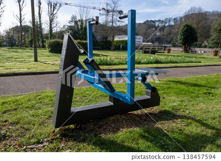 Outdoor fitness machine in park gym area public workout equipment in green urban landscape 138457594