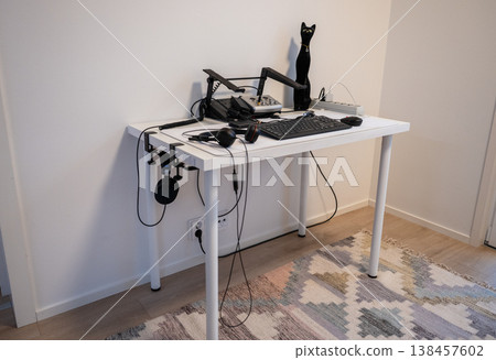 Minimalist home office workspace with computer keyboard headphones and modern desk setup in clean interior style Minimalist home office workspace with computer keyboard headphones and modern desk setup in clean interior style 138457602