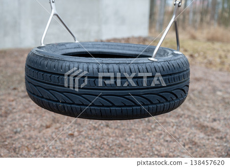 Tire swing in playground outdoor leisure activity childhood recreation concept 138457620