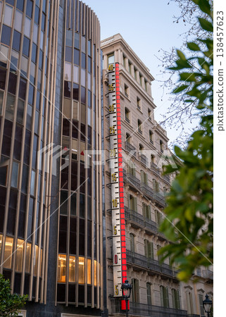 Outdoor thermometer on building facade showing temperature in Barcelona Spain urban architecture city detail 138457623
