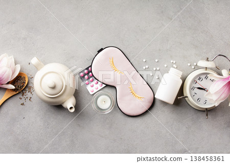 Healthy Sleep Routine Concept with Silk Mask, Herbal Tea and Alarm Clock Healthy Sleep Routine Concept with Silk Mask, Herbal Tea and Alarm Clock 138458361