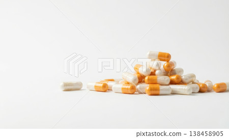 Capsule medicine supplement pill pharmacy healthcare nad longevity concept with orange white capsule pile on clean white background for wellness treatment dosage and minimal medical still life 138458905
