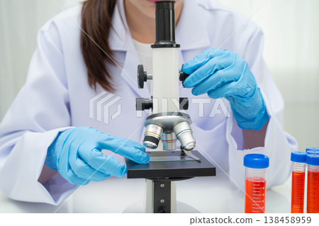 Scientist medical professional use microscope for research in science laboratory. Scientist medical professional use microscope for research in science laboratory. 138458959