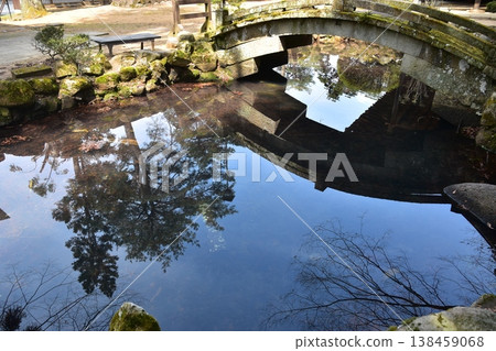 A retro temple located on the Higashiyama walking trail in Takayama City, Gifu Prefecture, Japan. The Japanese architectural structure and the scenery reflected in the pond create a beautiful, mirror-like effect. A retro temple located on the Higashiyama walking trail in Takayama City, Gifu Prefecture, Japan. The Japanese architectural structure and the scenery reflected in the pond create a beautiful, mirror-like effect. 138459068