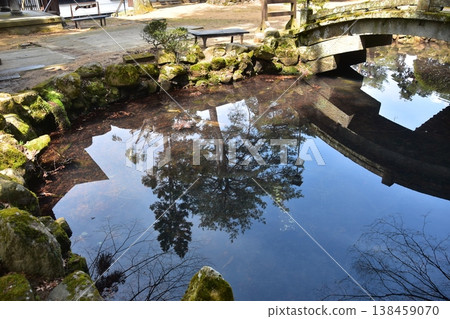 A retro temple located on the Higashiyama walking trail in Takayama City, Gifu Prefecture, Japan. The Japanese architectural structure and the scenery reflected in the pond create a beautiful, mirror-like effect. A retro temple located on the Higashiyama walking trail in Takayama City, Gifu Prefecture, Japan. The Japanese architectural structure and the scenery reflected in the pond create a beautiful, mirror-like effect. 138459070