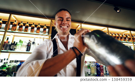 Bartender smiling while mixing a cocktail at bar 138459359