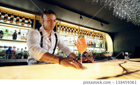 Bartender serving cocktail in modern bar setting 138459361