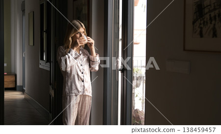 Thoughtful transgender woman in nightwear drinking coffee at home Thoughtful transgender woman in nightwear drinking coffee at home 138459457