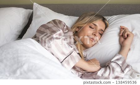 Relaxed transgender woman smiling while sleeping on bed during morning Relaxed transgender woman smiling while sleeping on bed during morning 138459536