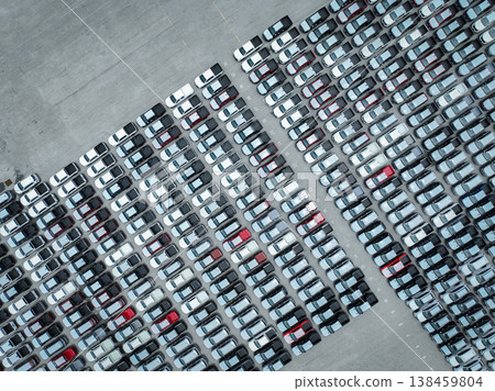 Aerial view of new cars stock at a large factory parking lot. Automotive industry, logistics operations, and vehicle storage for import and export. Key role in the global car market supply chain. Aerial view of new cars stock at a large factory parking lot. Automotive industry, logistics operations, and vehicle storage for import and export. Key role in the global car market supply chain. 138459804