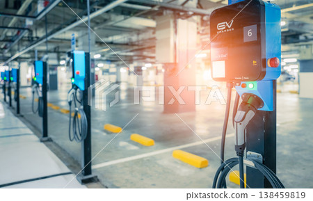 Electric car charging station for charge EV battery. Plug for vehicle with electric engine. EV charger. Clean energy. Charging point at car parking lot. Green power. Future transport technology. 138459819